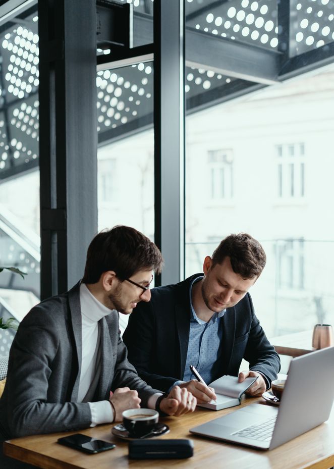 two-young-businessman-having-successful-meeting-restaurant